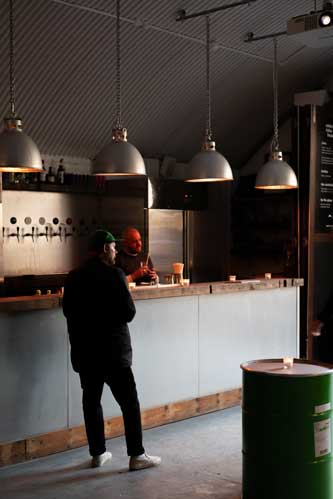 A man stood next to a bar