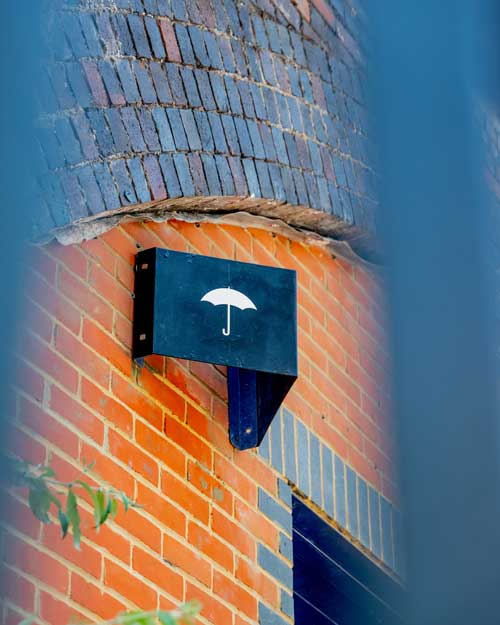 umbrella logo on sign outside railway arches