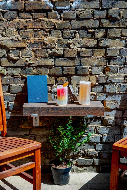 Two pints on an outside table in a courtyard